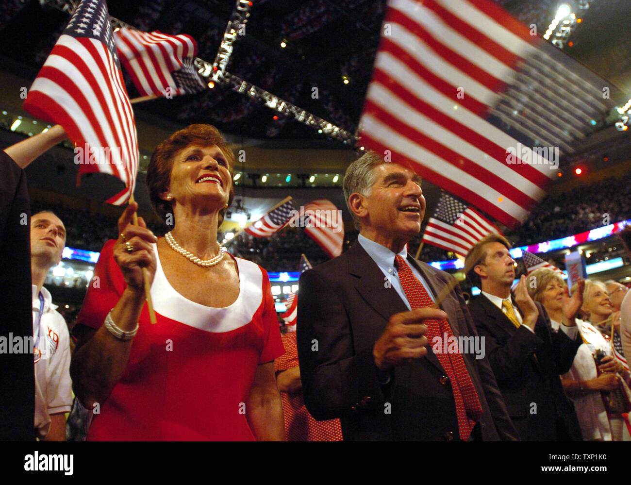 Former Mass. Gov. Michael Dukakis and his wife Kitty wave flags during 'Small Town' by John Mellencamp on day three of the Democratic National Convention at the FleetCenter in Boston on July 28, 2004.  (UPI Photo/Greg Whitesell) Stock Photo