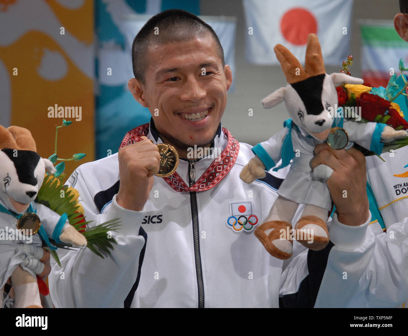 Japan S Tatsuaki Egusa Holds Up His Gold Medal For The Men S 60kg Judo Competition At The Asian Games In Doha Qatar On December 5 06 Thirteen Thousand Athletes From 39 Countries Are Japan S Tatsuaki Egusa Holds Up His Gold Medal For The Men S 60kg Judo Competition At The Asian Games In Doha Qatar On December 5 06 Thirteen Thousand Athletes From 39 Countries Are