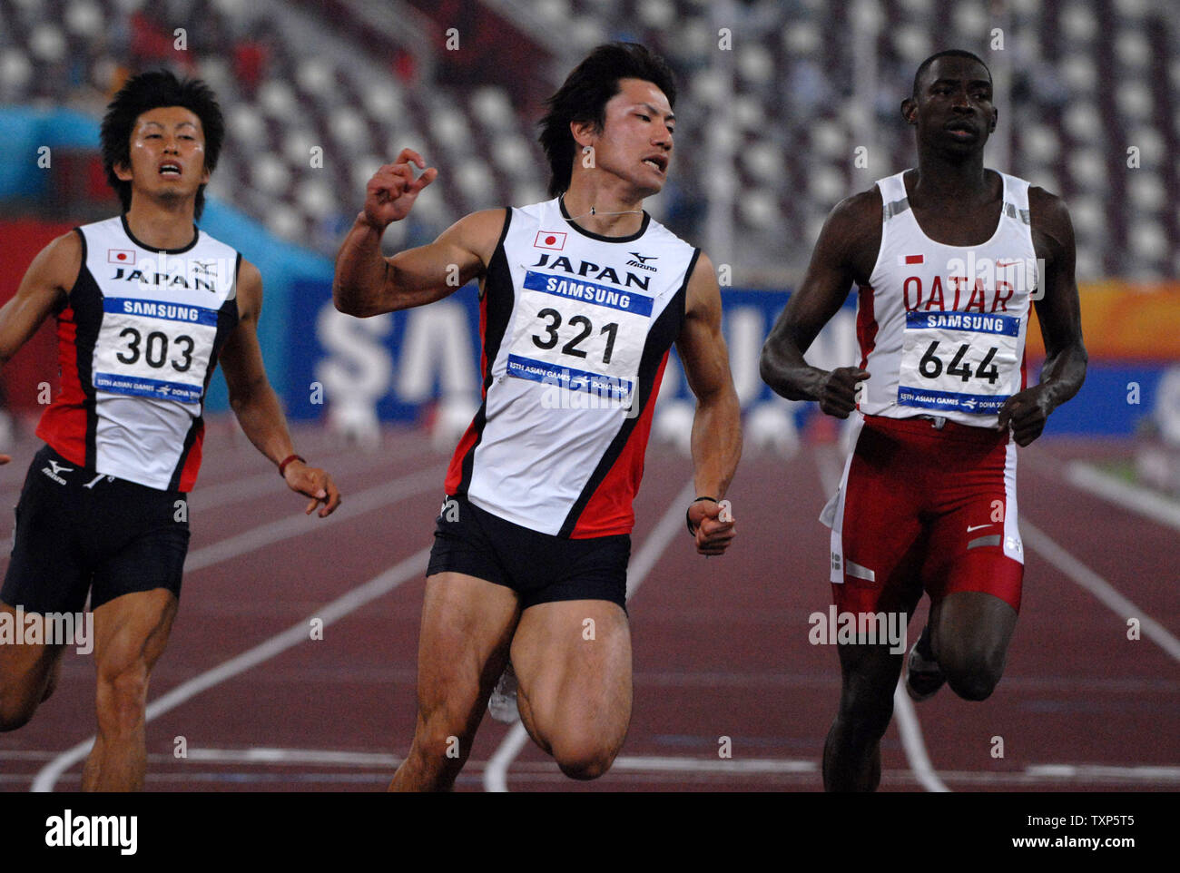 Japan's Naoki Tsukahara (center) wins the silvermedal in the men's 100 meters at the 15th Asian Games in Doha Qatar, Saturday December 9, 2006.  Saudia Arabia's Yahya Hassan Habeeb medal and Thailands' Wachara Sondee win's the gold medal. Thirteen thousand athletes from 39 countries are competing in 45 sporting events over two weeks. The games will end on December 15. (UPI Photo/Norbert Schiller) Stock Photo