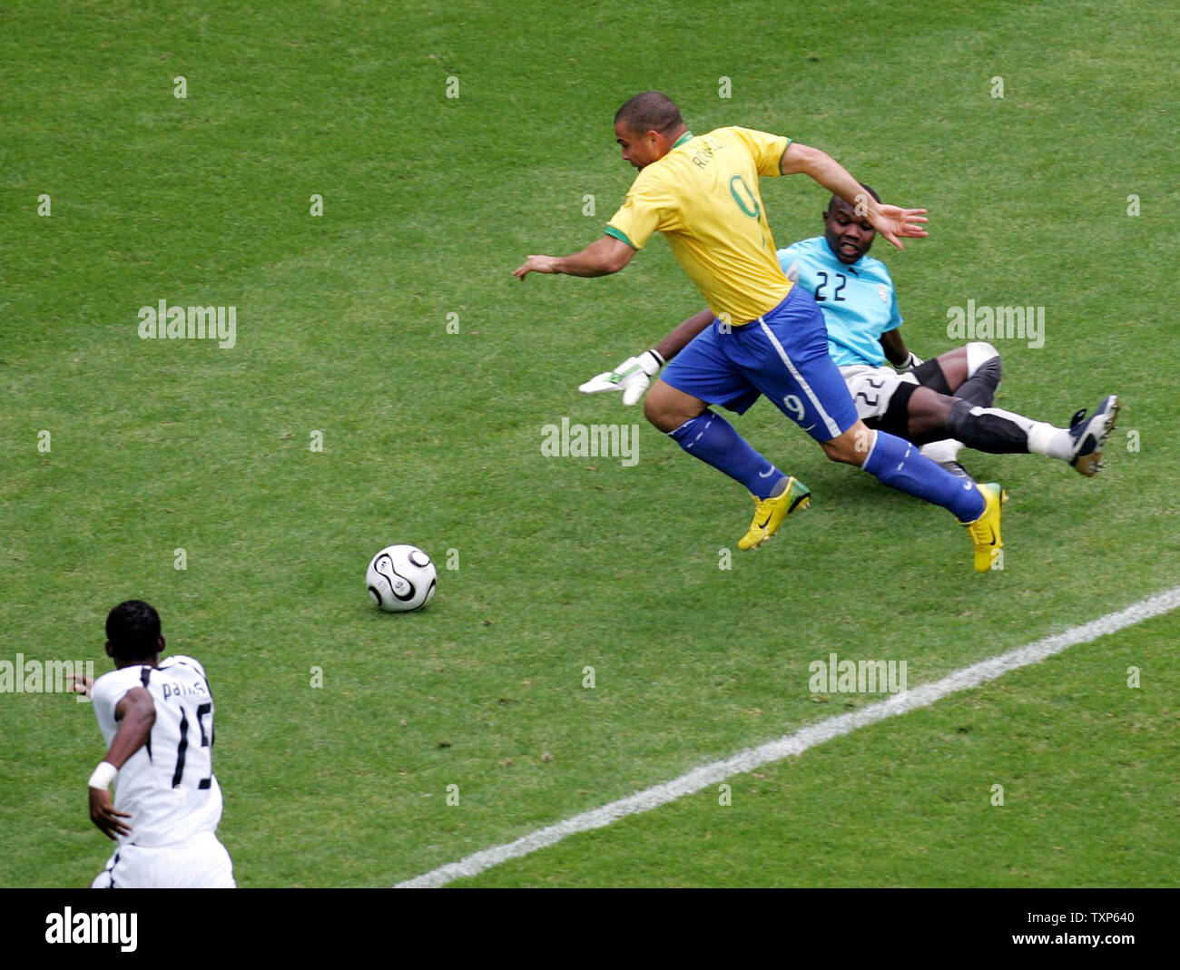 The first goal of the match after only five minutes is scored by Brazil's Ronaldo (yellow) as he moves the ball past Ghana's goalie in World Cup action in Dortmund, Germany on June 27, 2006.  Brazil beat Ghana 3-0.   (UPI Photo/Arthur Thill) Stock Photo