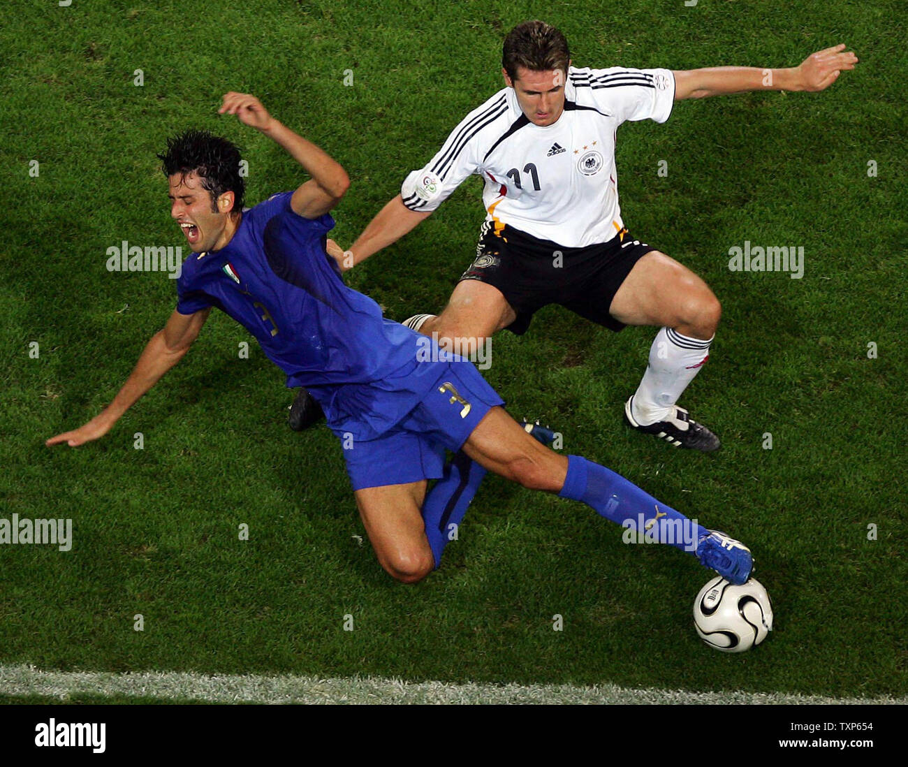 Germany's Miroslav Klose and Italy's Fabio Grosso fight for the ball during World Cup soccer in Dortmund, Germany on July 4, 2006.  Italy defeated Germany 2-0.   (UPI Photo/CHRISTINE BRU                     ) Stock Photo