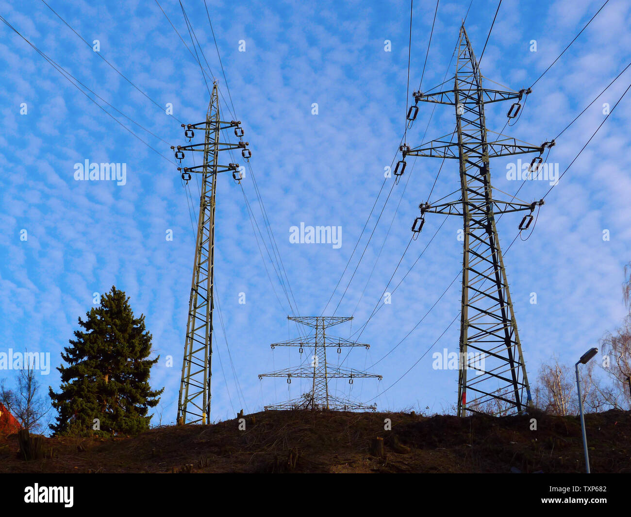 Three types of power line poles in the landscape Stock Photo Alamy