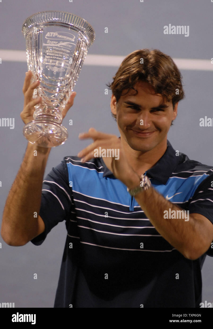 The world's number one tennis player, Roger Federer, receives a trophy from  the Association of Tennis Professionals and Dubai Duty Free celebrating his  161st consecutive week as the ATP number one ranked