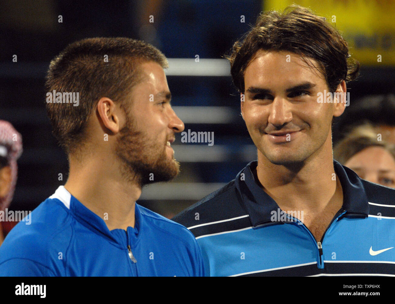 The world's number one tennis player Roger Federer (R) speaks with Russia's  Mikhail Youzhny during awards ceremony after Federer defeated Youzhney 6-4  6-3 in the finals of the Men's Dubai Tennis Championships