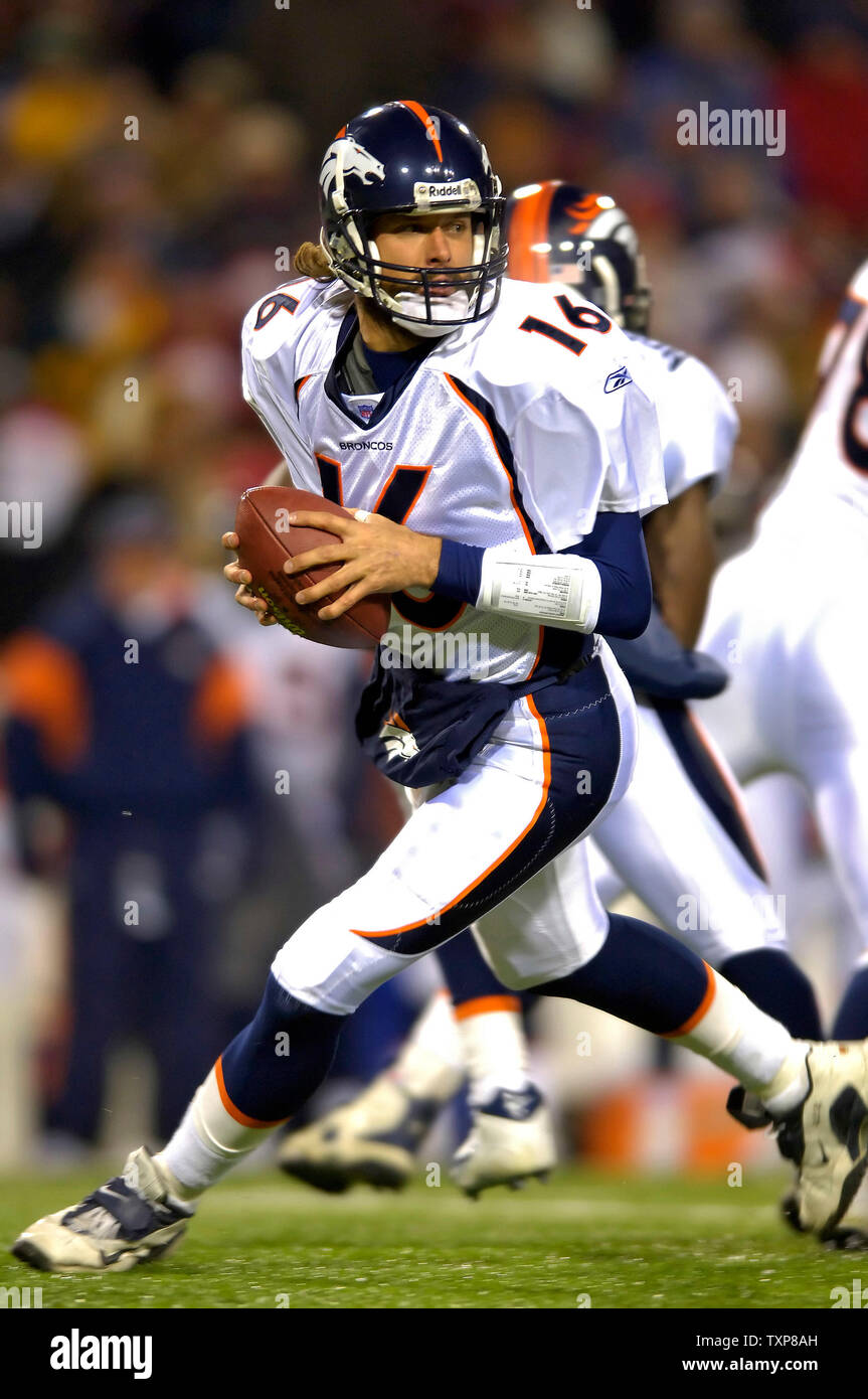 Denver Broncos quarterback Jake Plummer (C) follows his right and left  guards Cooper Carlisle (L) and Ben Hamilton (R) on a one-yard touchdown run  against the Indianapolis Colts, left tackle Anthony McFarland (