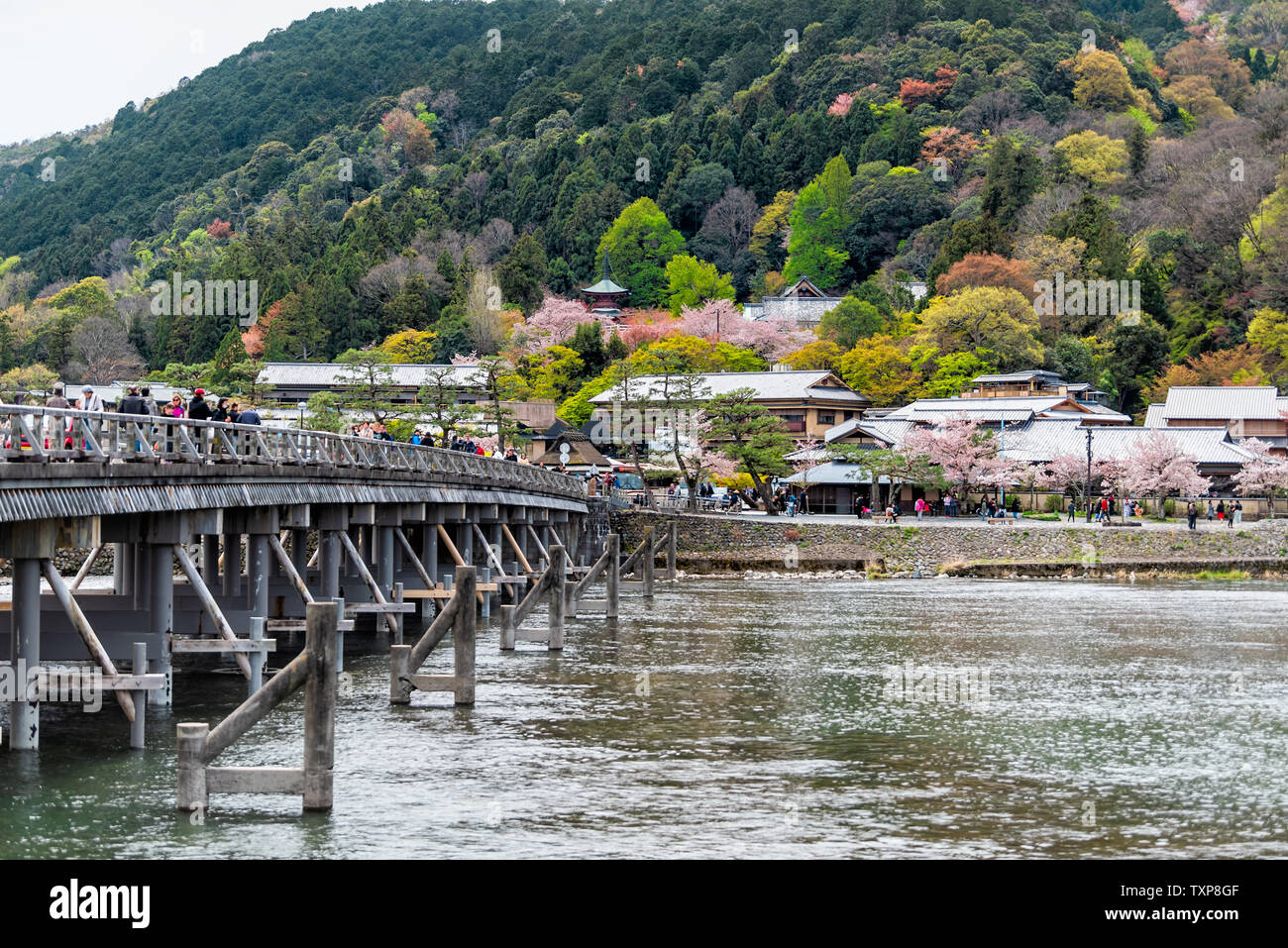 Kyoto, Japan - April 11, 2019: Arashiyama Togetsukyo Bridge during day with many people tourists walking by mountain in spring and Katsura river Stock Photo