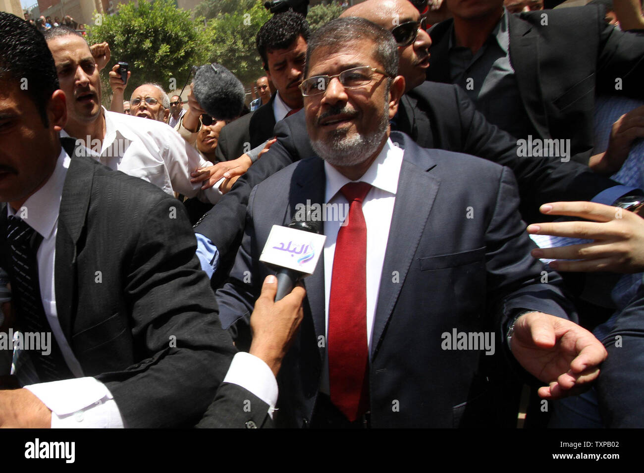 Presidential candidate Mohamed Morsy(C) of the Muslim Brotherhood arrives to cast his vote at a polling station in a school in Al-Sharqya, 60 km (37 miles) northeast of Cairo in Egypt, June 16, 2012. Egypt's first free presidential election concludes this weekend in a run-off between the Muslim Brotherhood's candidate Mohamed Morsy and Ahmed Shafik, the last prime minister of ousted leader Hosni Mubarak. UPI/Ahmed Jomaa Stock Photo