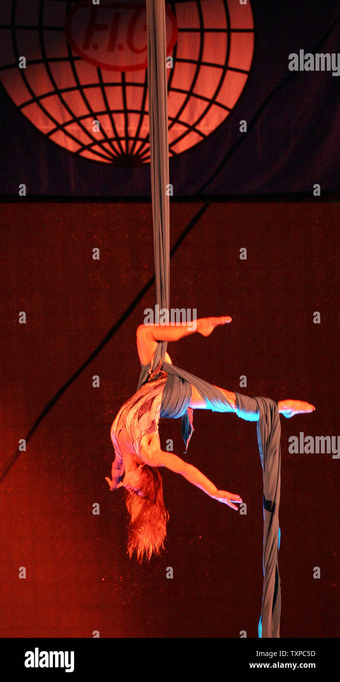 An acrobat performs in the opening ceremonies of the 24th Trampoline ...
