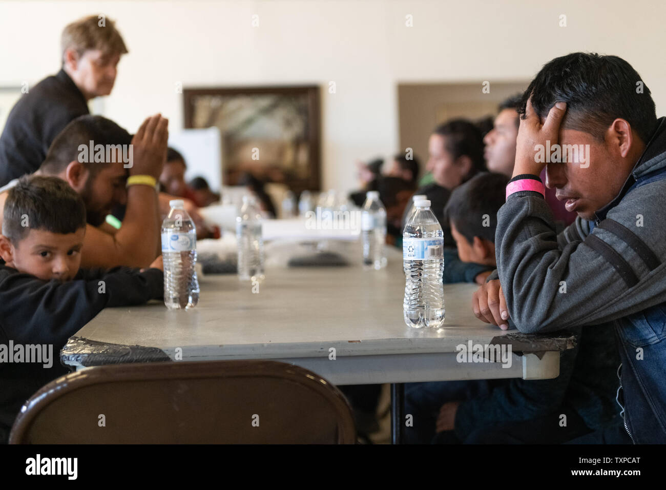 Migrants pray before lunch is served at Camino de Vida in El Paso, Texas on March 22, 2019. Border Patrol detention centers have soared past capacity, prompting the mass release of upwards of 600 migrants per day from March 22 through March 24, 2019.      Photo by Justin Hamel/UPI Stock Photo