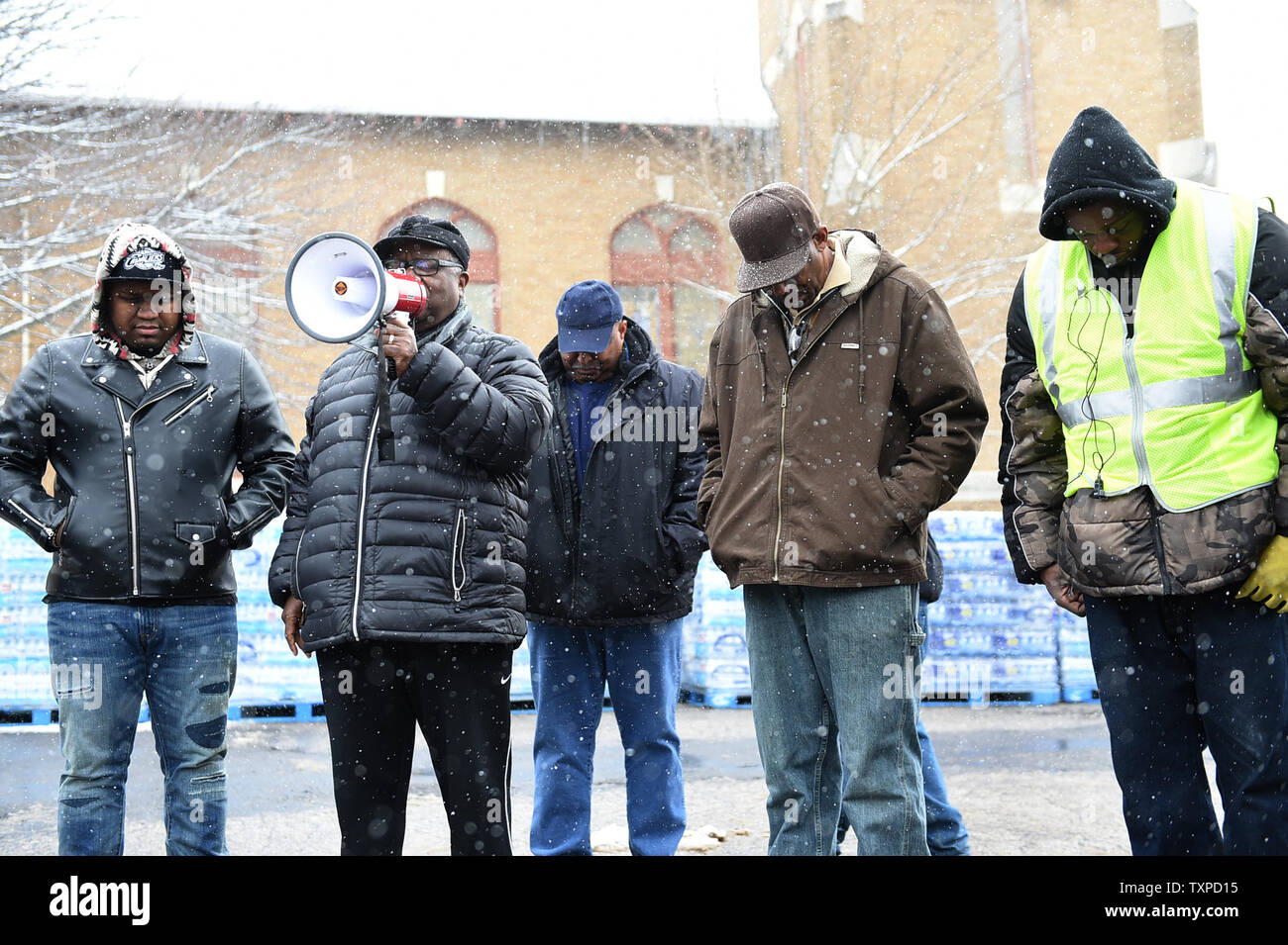 Lawrence Kirby from Racine, Wi, 2nd left, leads a prayer at Joy