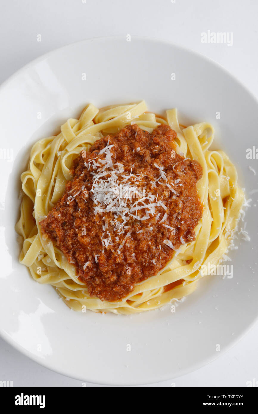 Delicious Fresh Fettuccine Pasta with Bolognese sauce and sprinkled with Permesan Cheese Stock Photo
