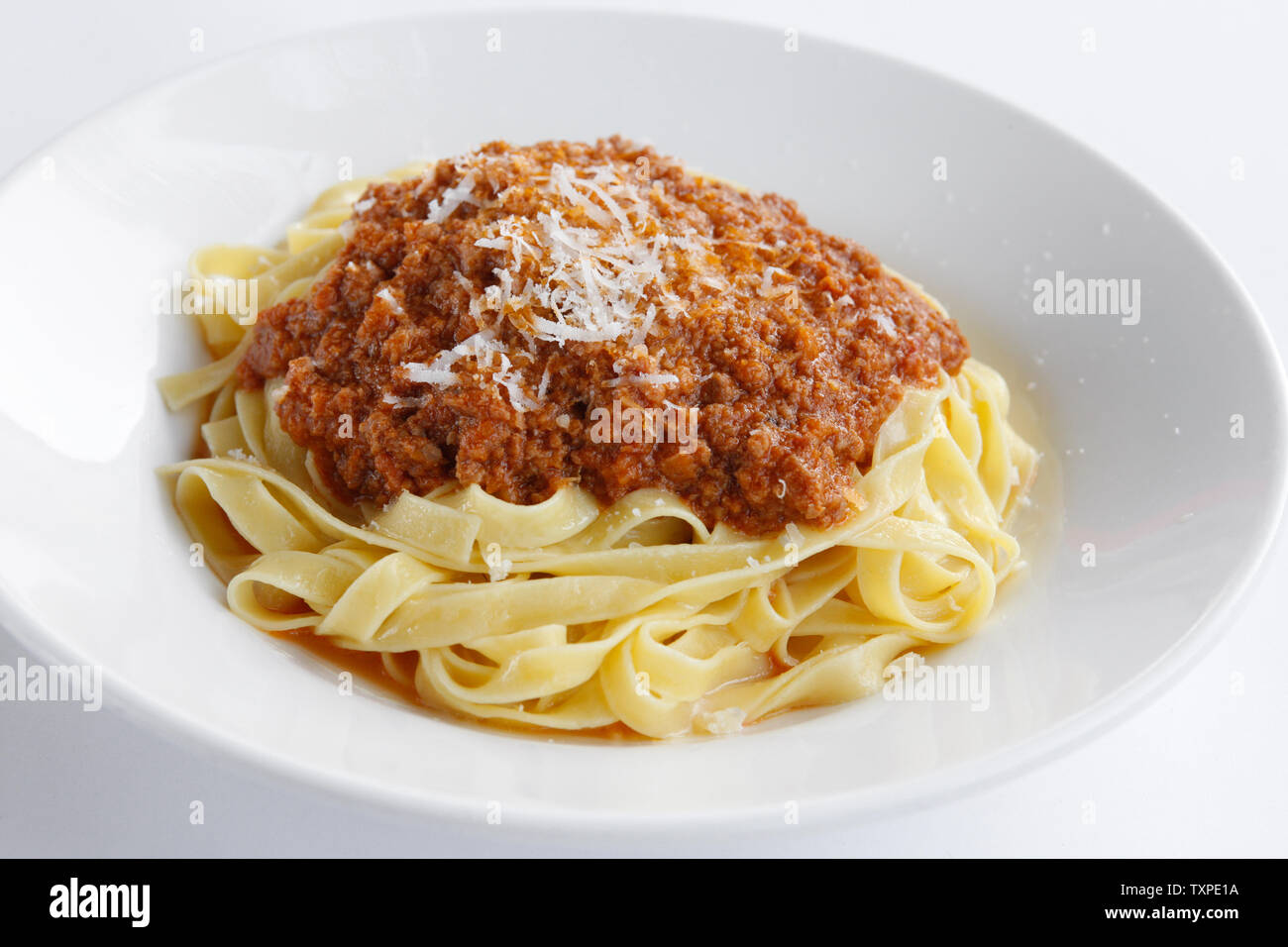 Delicious Fresh Fettuccine Pasta with Bolognese sauce and sprinkled with Permesan Cheese Stock Photo