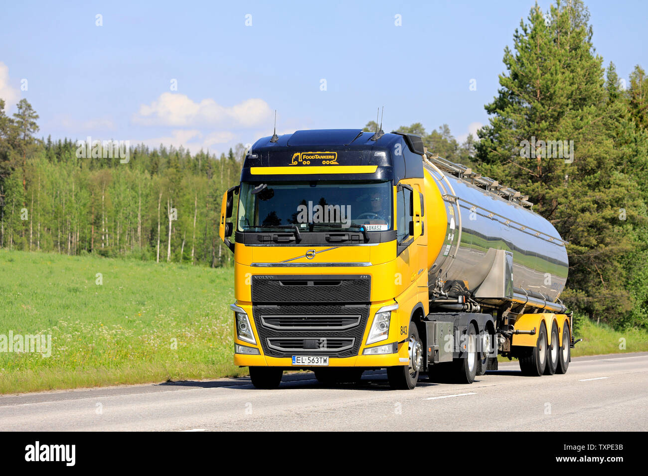 Uurainen, Finland. June 8, 2019. Yellow Volvo FH 460 semi tank truck Foodtankers driving along highway on a sunny day of summer. Stock Photo