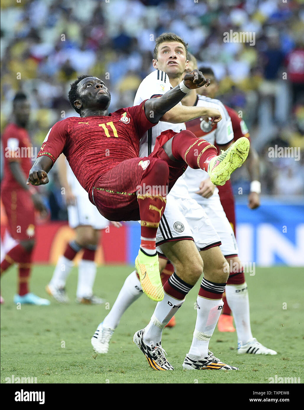 Thomas Muller of Germany competes with Sulley Muntari (L) of Ghana during the 2014 FIFA World Cup Group G match at the Estadio Castelao in Fortaleza, Brazil on June 21, 2014. UPI/Chris Brunskill Stock Photo