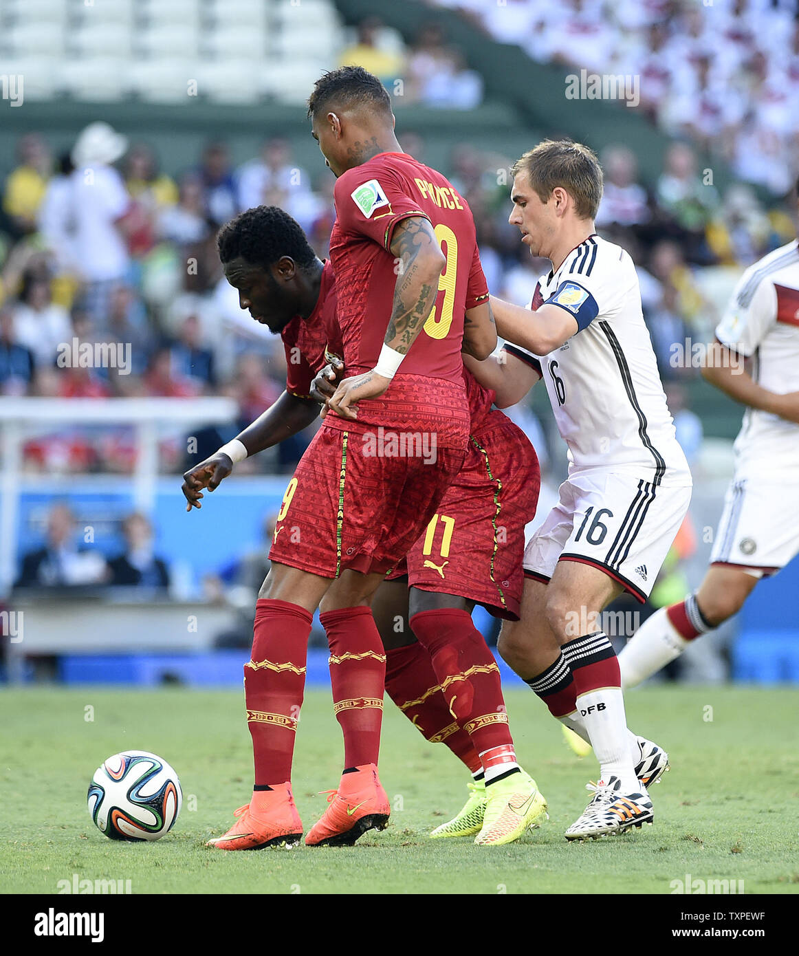 Philipp Lahm of Germany competes with Sulley Muntari (L) of Ghana during the 2014 FIFA World Cup Group G match at the Estadio Castelao in Fortaleza, Brazil on June 21, 2014. UPI/Chris Brunskill Stock Photo