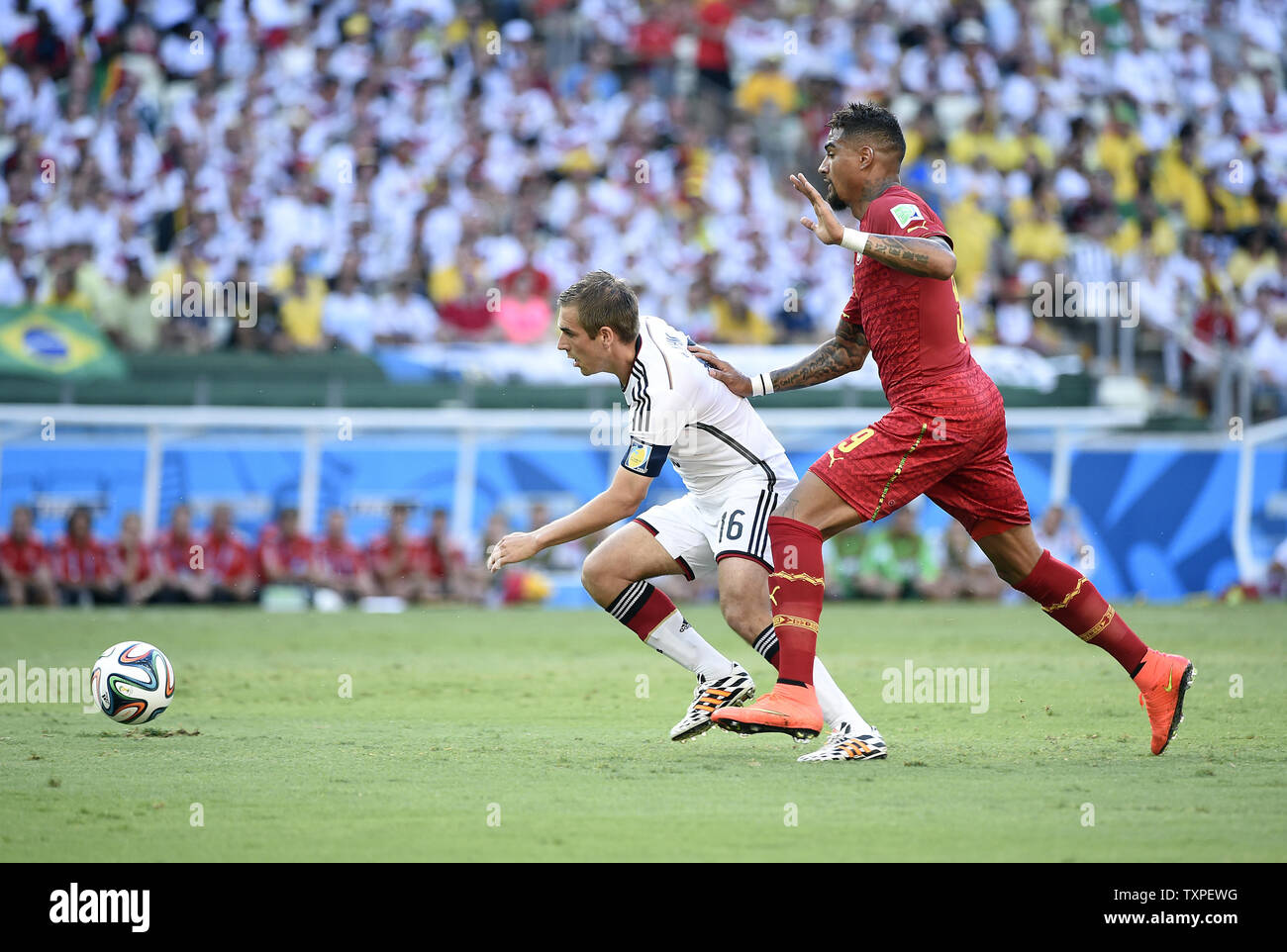 Philipp Lahm (L) of Germany competes with Kevin Prince-Boateng of Ghana during the 2014 FIFA World Cup Group G match at the Estadio Castelao in Fortaleza, Brazil on June 21, 2014. UPI/Chris Brunskill Stock Photo