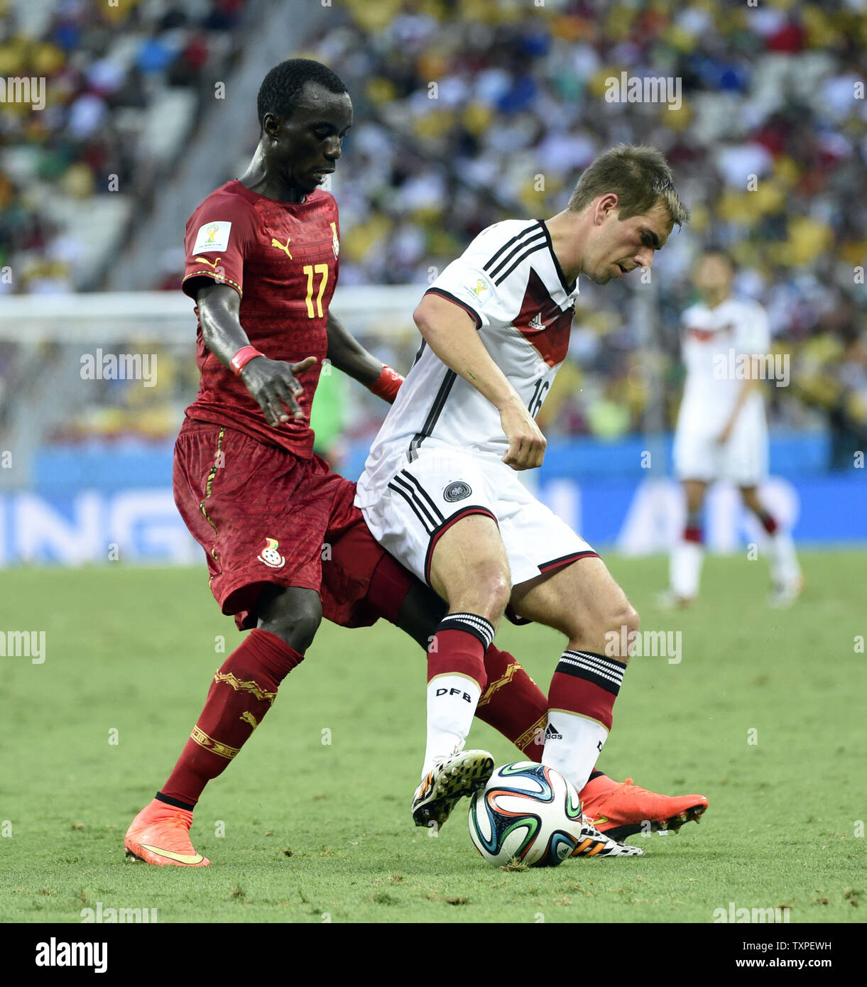 Philipp Lahm of Germany competes with Mohammed Rabiu (L) of Ghana during the 2014 FIFA World Cup Group G match at the Estadio Castelao in Fortaleza, Brazil on June 21, 2014. UPI/Chris Brunskill Stock Photo
