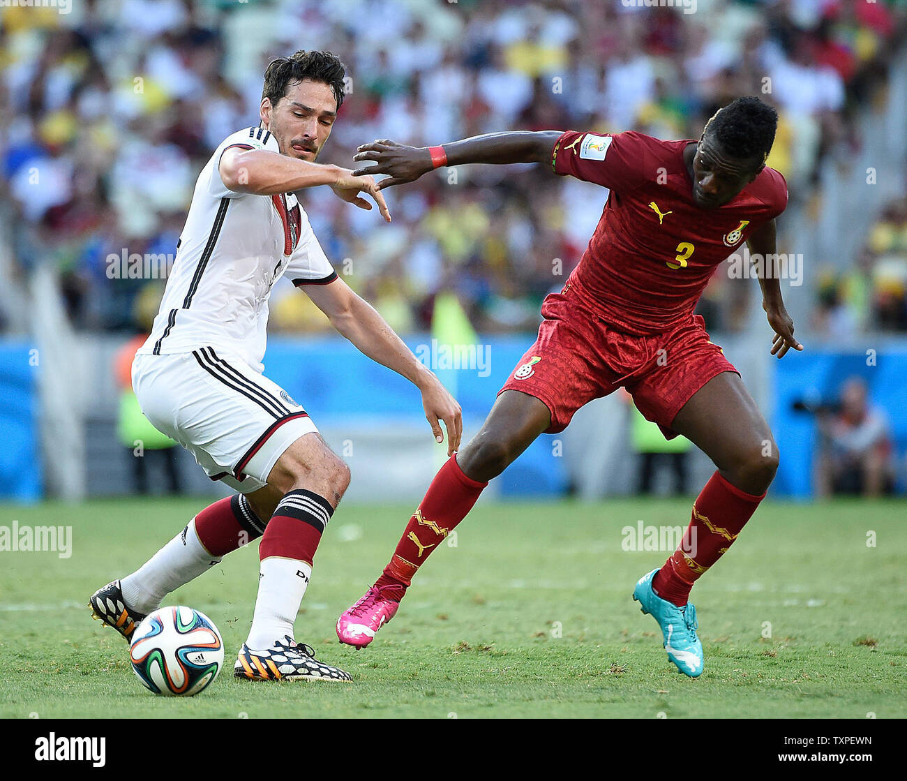 Mats Hummels (L) of Germany competes with Asamoah Gyan of Ghana during the 2014 FIFA World Cup Group G match at the Estadio Castelao in Fortaleza, Brazil on June 21, 2014. UPI/Chris Brunskill Stock Photo