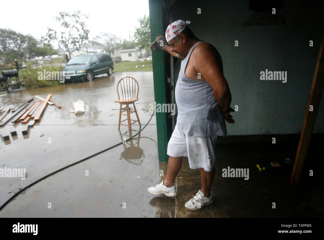 Joe Martinez takes a break from starting to clean up the damage at his home in the wake of Hurricane Ike in Galveston, Texas on September 14, 2008. Hurricane Ike hit the Texas coast yesterday September 13, 2008. (UPI Photo/Aaron M. Sprecher) Stock Photo