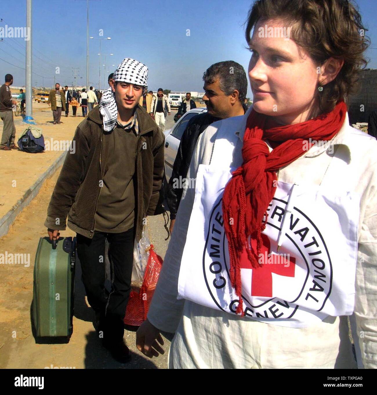 Palestinian prisoners  are greeted by relatives and members of the Red Cross after being released by authorities from an Israeli jail, at the Erez Crossing, northern Gaza Strip on January 29, 2004. Israel released 400 Palestinian prisoners Thursday as part of a swap with Lebanese guerrilla group Hezbollah. Jubilant relatives greeted the freed prisoners at checkpoints Gaza Strip with cheers of thanks to Hezbollah.  (UPI photo/Ismail Mohamad) Stock Photo