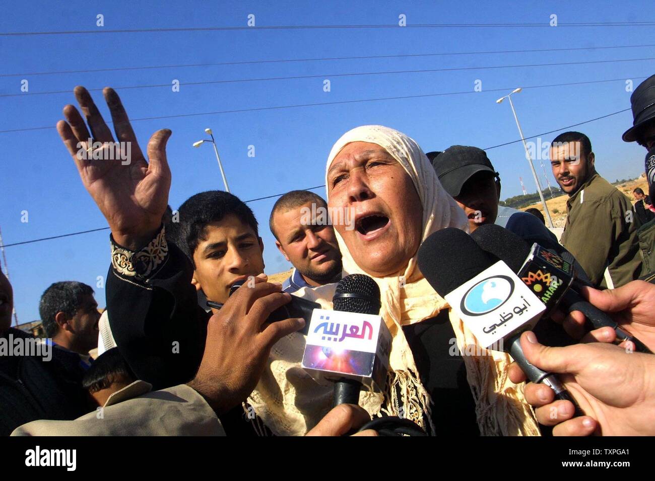 Palestinian relatives are greet the prisoners after being released by authorities from an Israeli jail, at the Erez Crossing, northern Gaza Strip, on January 29, 2004. Israel released 400 Palestinian prisoners Thursday as part of a swap with Lebanese guerrilla group Hezbollah. Jubilant relatives greeted the freed prisoners at checkpoints Gaza Strip with cheers of thanks to Hezbollah. (UPI photo/Ismail Mohamad) Stock Photo
