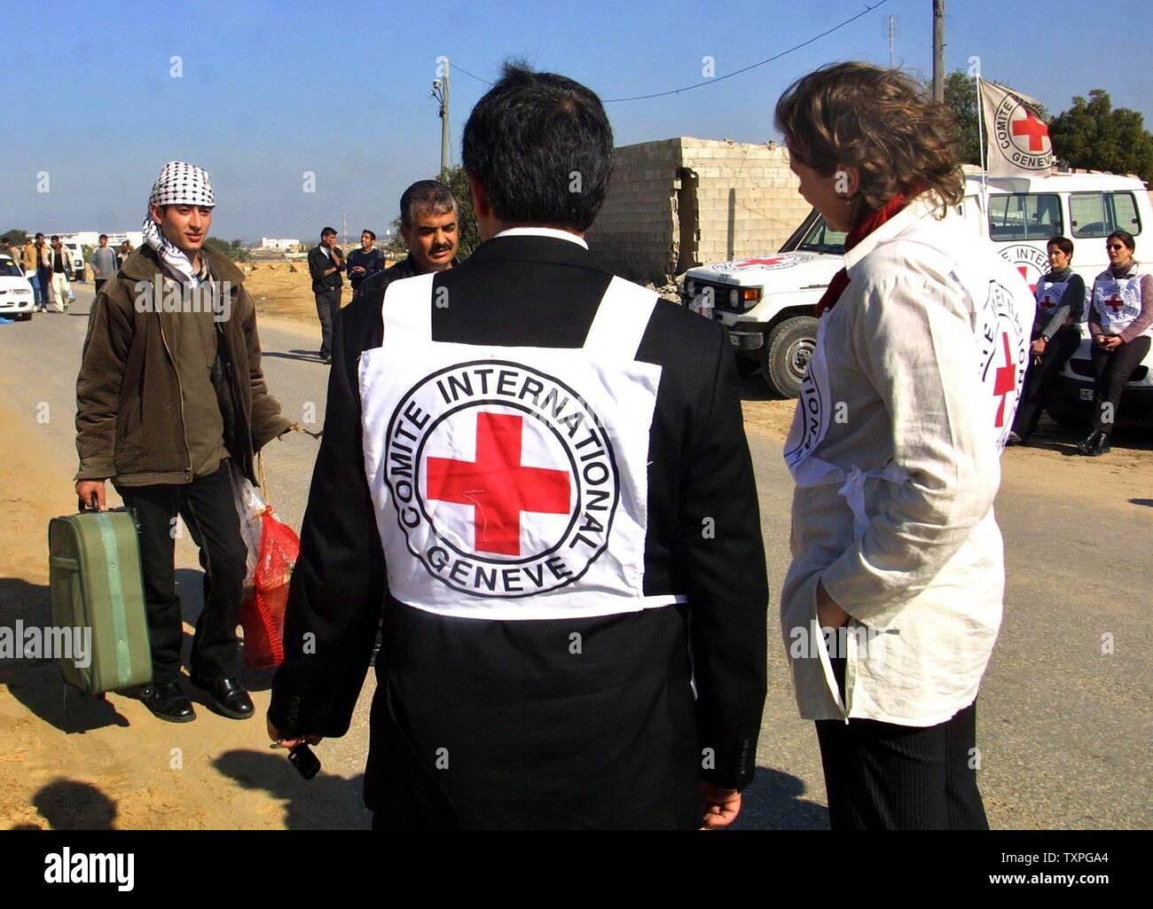 A Palestinian prisoner shakes hands with Red Cross employees after crossing into the Palestinian side of the Erez crossing along the Gaza-Israeli border on January 29, 2004. Israel began releasing more than 400 Palestinian prisoners as part of a controversial exchange deal with the Lebanese Hezbollah militia. (UPI Photo/Ismail Mohamad) Stock Photo