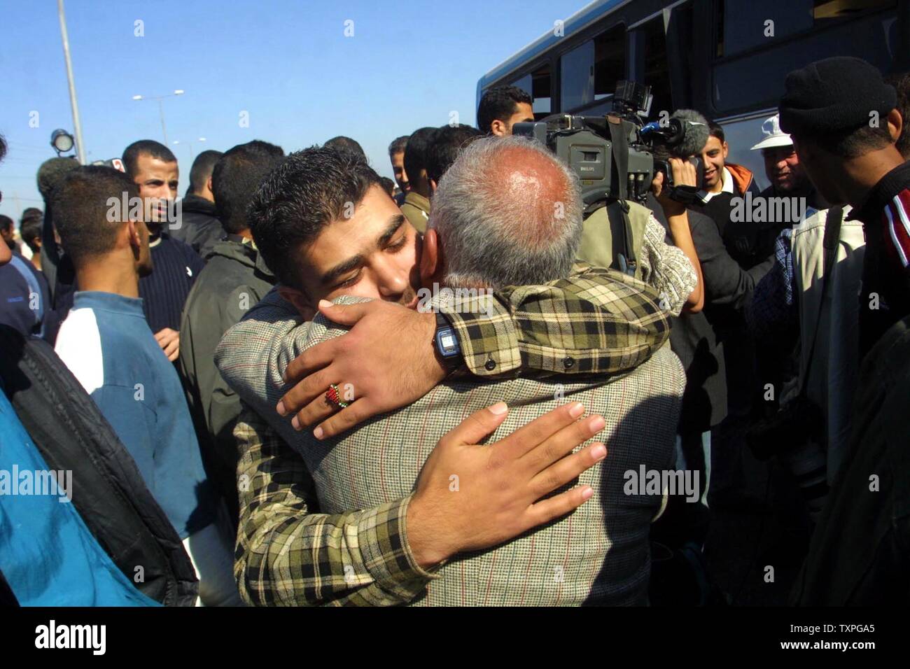 Palestinian prisoners  are greeted by relatives after being released by authorities from an Israeli jail, at the Erez Crossing, northern Gaza Strip on January 29, 2004. Israel released 400 Palestinian prisoners Thursday as part of a swap with Lebanese guerrilla group Hezbollah. Jubilant relatives greeted the freed prisoners at checkpoints Gaza Strip with cheers of thanks to Hezbollah.  (UPI photo/Ismail Mohamad) Stock Photo