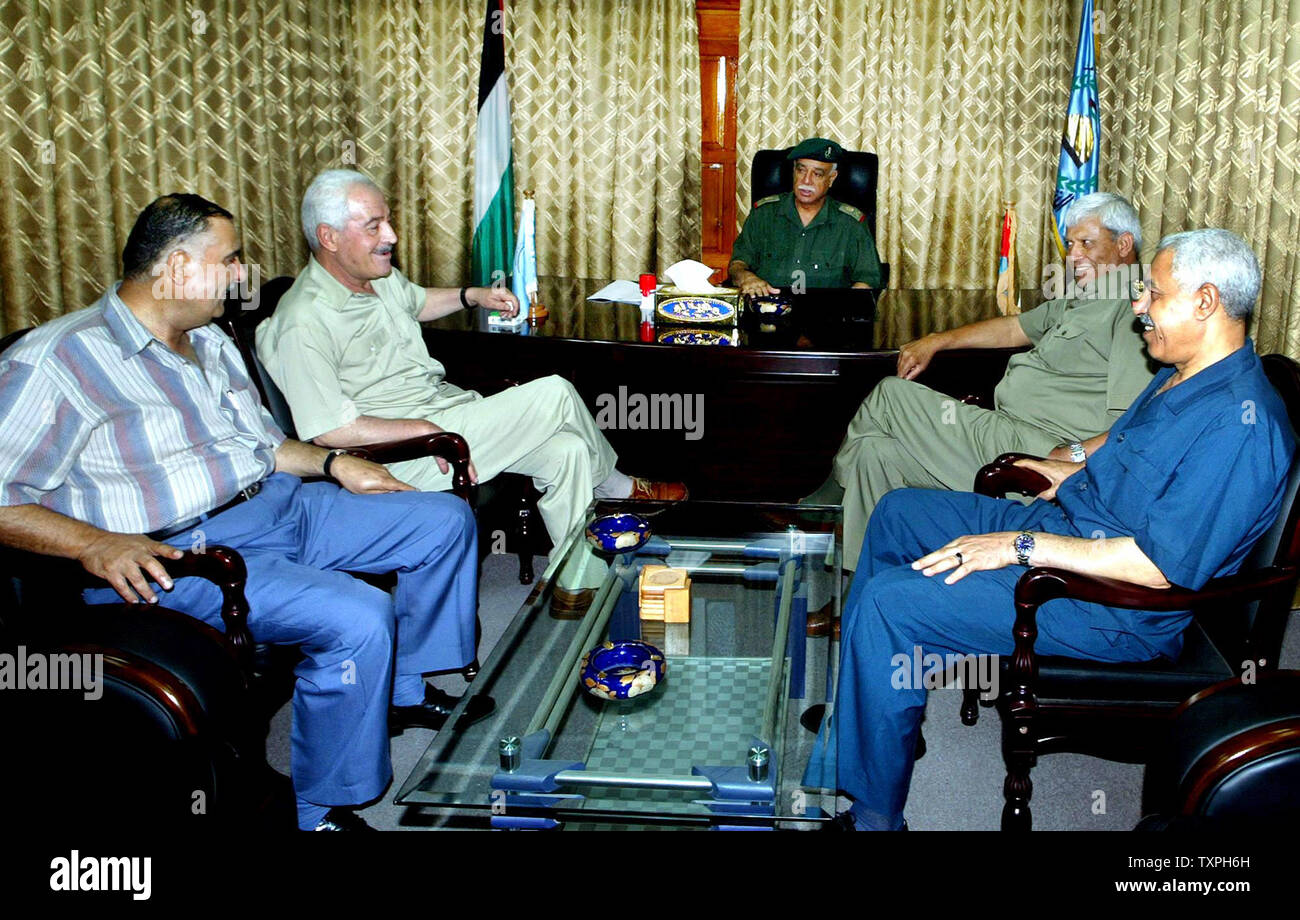 Abdel Razzak al-Majaideh (C) former head of Palestinian National Security who was replaced by Moussa Arafat, ousted former Gaza police chief Ghazi Jabali (2nd-L) and Major-General Saeb al-Ajez (2nd-R), the new Palestinian police chief are seen July 17, 2004 in police headquarters in Gaza City. (UPI Photo/Ismael Mohamad) Stock Photo