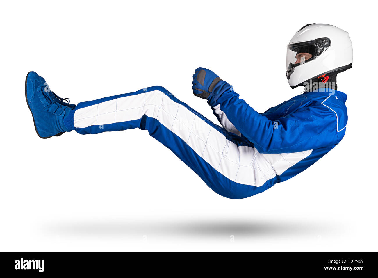 Race driver in blue white motorsport overall hover over ground in driving seat position with shoes gloves and safety crash helmet, isolated on white a Stock Photo