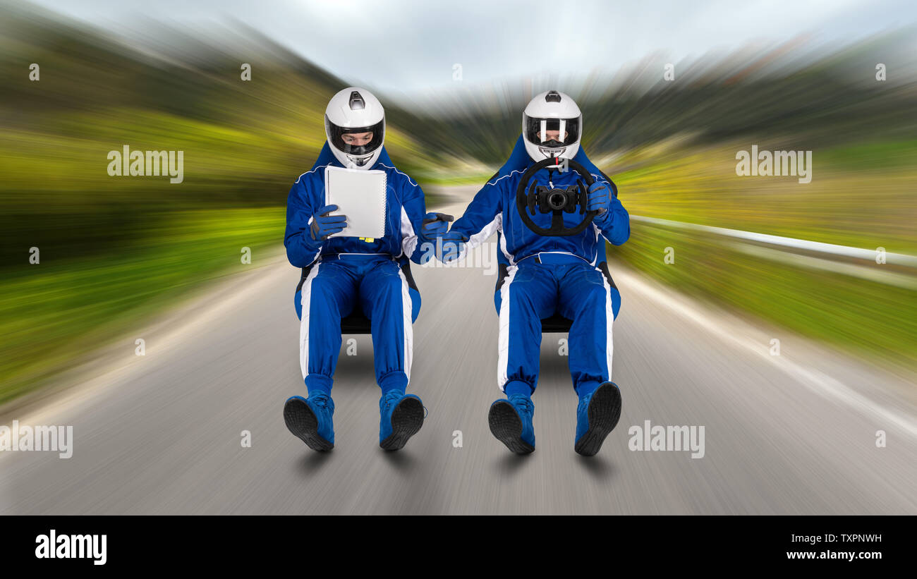 Rally drive and co-pilot passenger reading the pacenote book hover with speed on racing bucket seat on road street rallying stage abstract funny motor Stock Photo