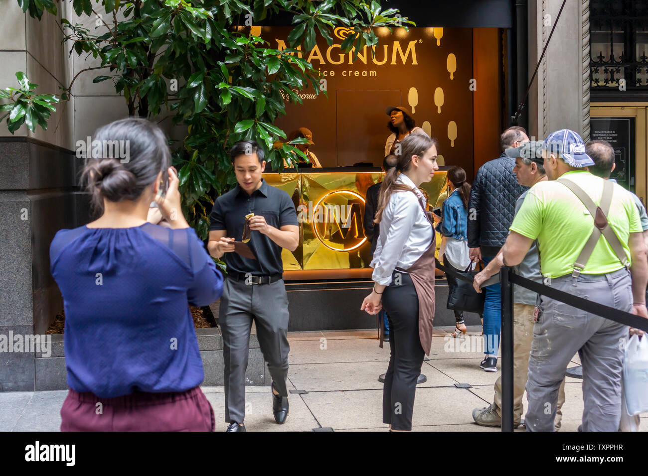 Ice Cream Lovers Step Up To A Window Of Saks Fifth Avenue In New York Which