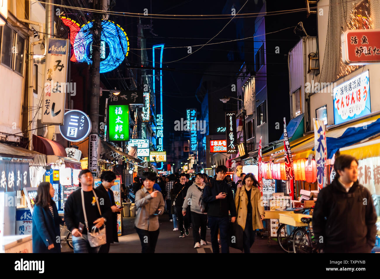 Osaka, Japan - April 13, 2019: Minami Namba street with people walking in dark night and illuminated buildings with colorful signs Stock Photo