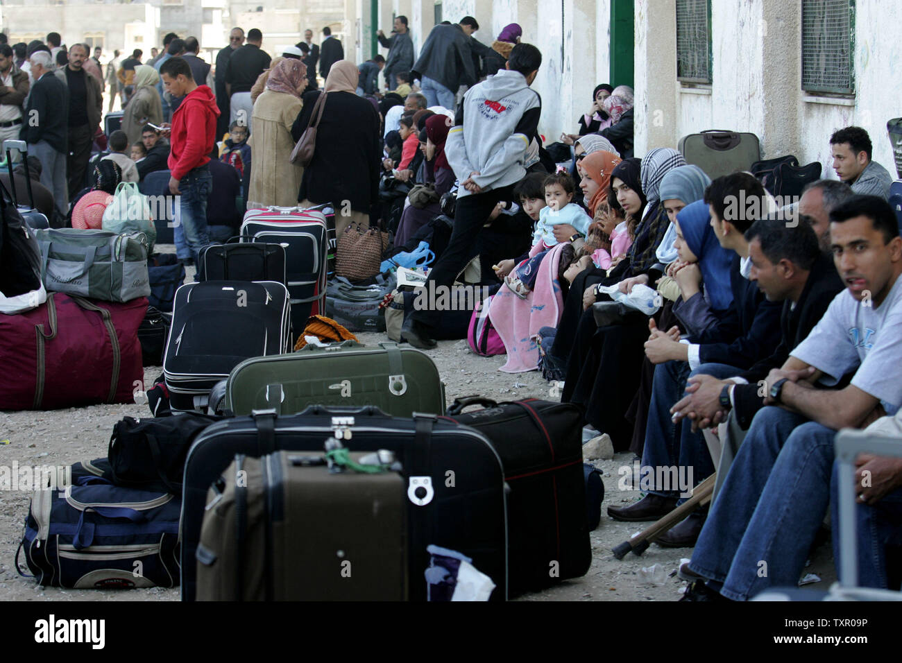 Palestinians Wait To Cross The Rafah Border Point Into Egypt From The ...