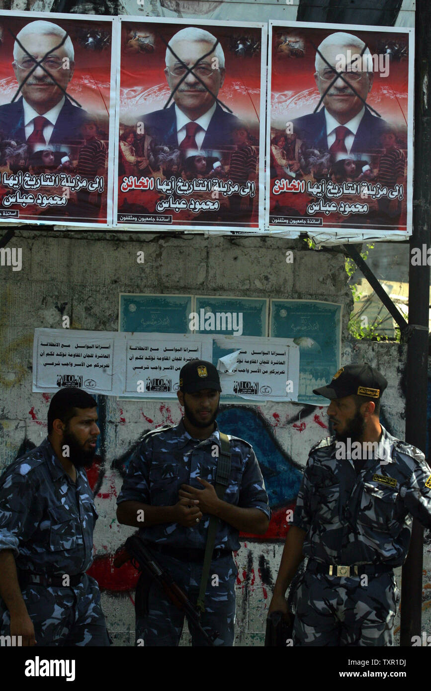 Palestinian police of Hamas stand by posters depicting Palestinian ...