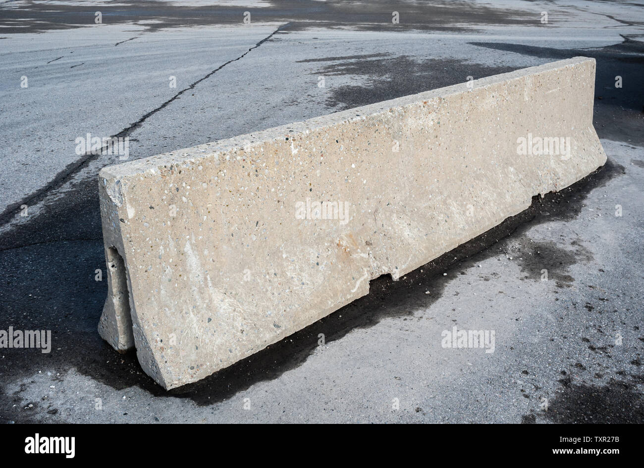 Concrete barrier on dirty empty asphalt Stock Photo Alamy