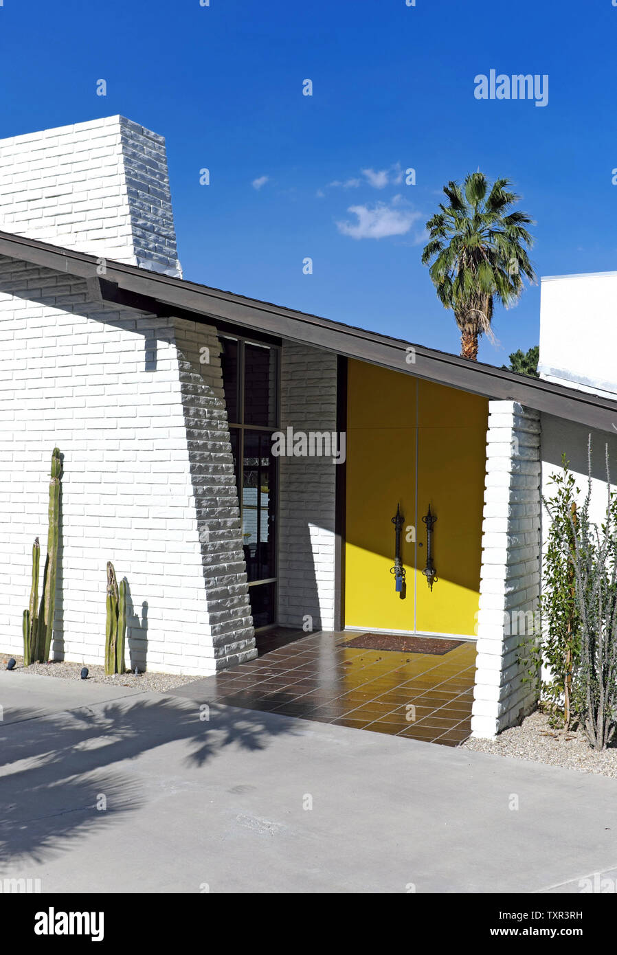 Mid Century modern home exterior with yellow doors in Palm Springs, California, USA. Stock Photo