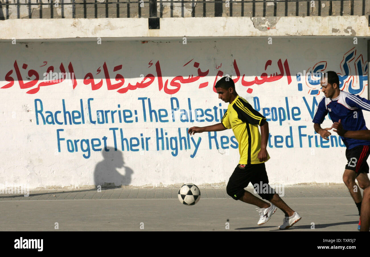 Palestinian youths play  football at a refugee camp in Rafah, in the southern Gaza Strip, on July 28, 2012, at the end of a local football match, named the 'Rachel Corrie Cup', in honour of the US peace activist who was run over by an Israeli bulldozer during a demonstration against the demolition of homes near the border of Rafah in the southern Gaza  with Egypt in 2003. Corrie's family had accused Israel of intentionally and unlawfully killing their 23-year-old daughter in March 2003, launching a civil case in the northern city of Haifa after a military investigation found the army was not r Stock Photo