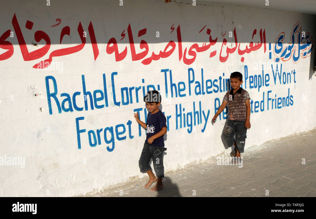 Palestinian boys walk at a refugee camp in Rafah, in the southern  Strip, on July 28, 2012, and watch a local football match, named the 'Rachel Corrie Cup', in honour of the US peace activist who was run over by an Israeli bulldozer during a demonstration against the demolition of homes near the border of Rafah in the southern Gaza  with Egypt in 2003. Corrie's family had accused Israel of intentionally and unlawfully killing their 23-year-old daughter in March 2003, launching a civil case in the northern city of Haifa after a military investigation found the army was not responsible. UPI/Isma Stock Photo