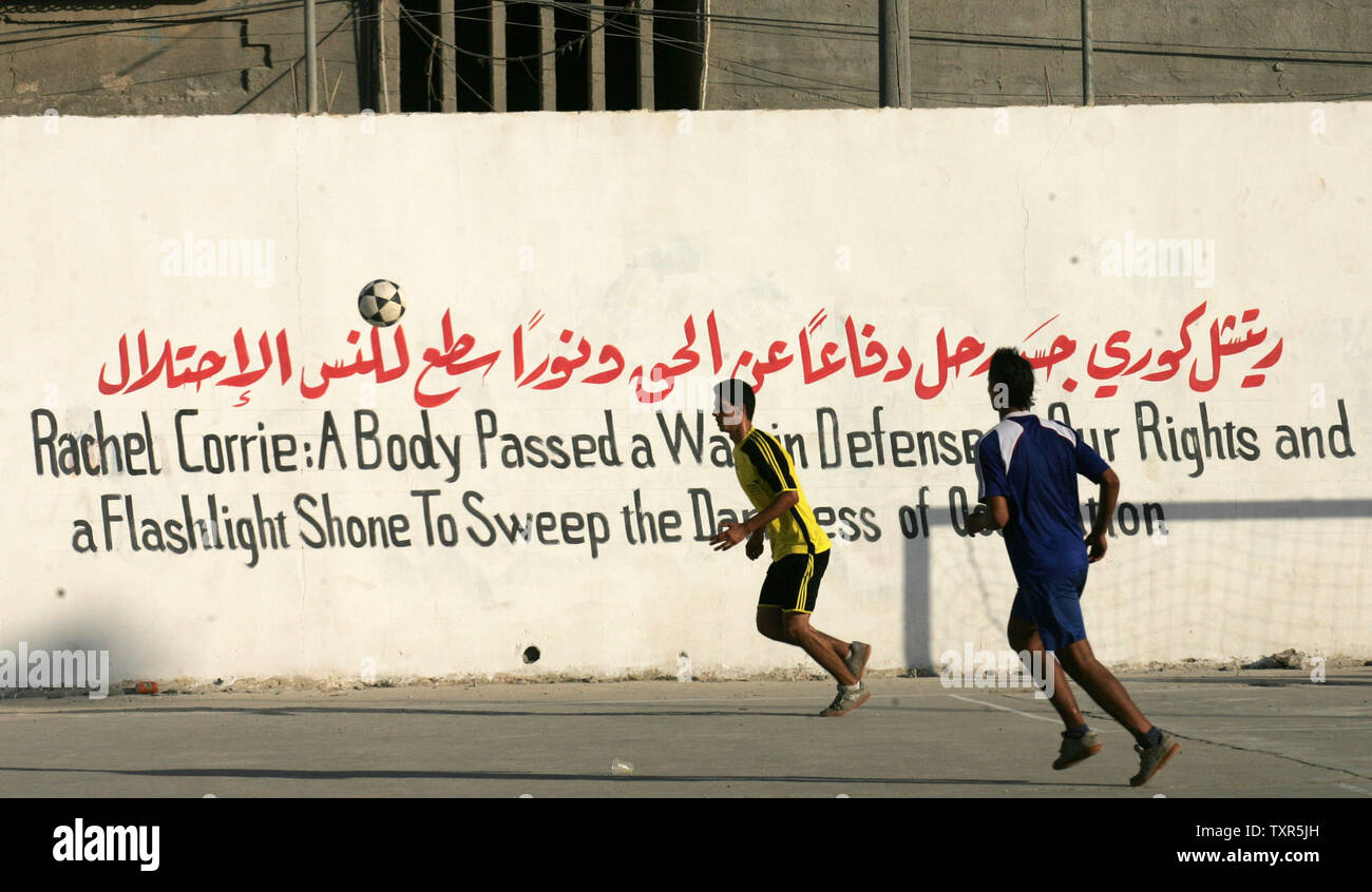 Palestinian youths play football at a refugee camp in Rafah, in the southern Gaza Strip, on July 28, 2012, at the end of a local football match, named the 'Rachel Corrie Cup', in honour of the US peace activist who was run over by an Israeli bulldozer during a demonstration against the demolition of homes near the border of Rafah in the southern Gaza Strip with Egypt in 2003. Corrie's family had accused Israel of intentionally and unlawfully killing their 23-year-old daughter in March 2003, launching a civil case in the northern city of Haifa after a military investigation found the army was n Stock Photo