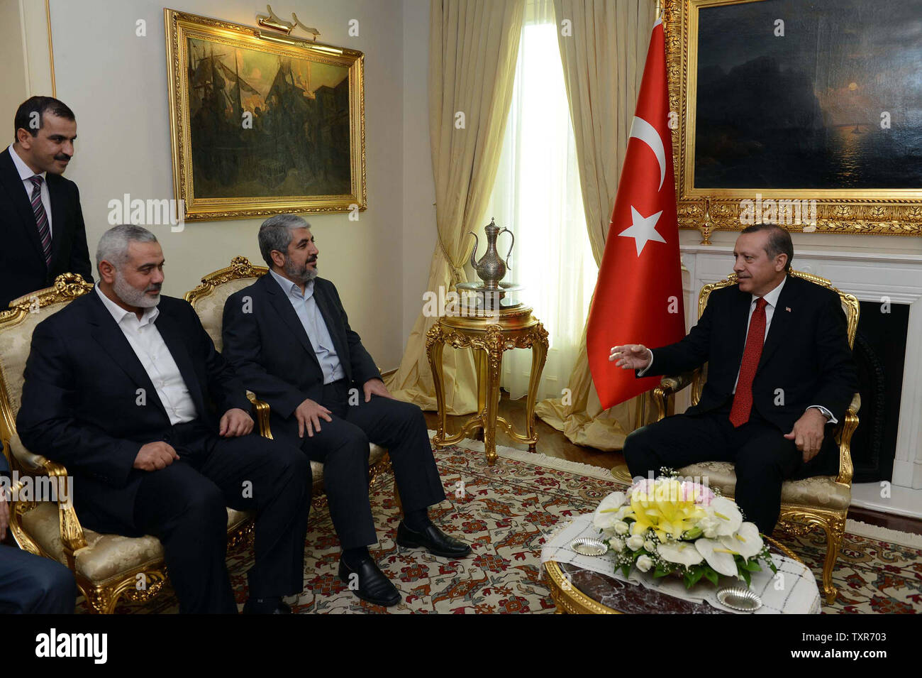 Turkish Prime Minister Recep Tayyip Erdogan (R) meets Khalid Mashaal (C), the Hamas chief in exile, and Gaza’s prime minister Ismail Haniyeh in Ankara, Turkey  on June 18, 2013. Senior leaders Hamas met today in Ankara with Erdogan to discuss Erdogan's planned visit to the Gaza Strip as well as the situation in Syria, the source said on condition of anonymity.    UPI/Palestinian PM Media Stock Photo
