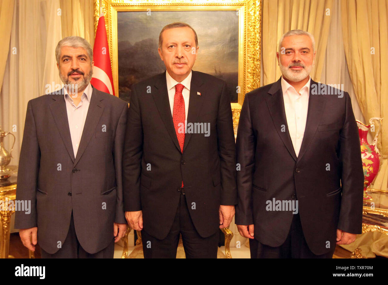 urkish Prime Minister Recep Tayyip Erdogan (C) meets Khalid Mashaal (L), the Hamas chief in exile, and Gaza’s prime minister Ismail Haniyeh in Ankara, Turkey  on June 18, 2013. Senior leaders Hamas met today in Ankara with Erdogan to discuss Erdogan's planned visit to the Gaza Strip as well as the situation in Syria, the source said on condition of anonymity.    UPI/Palestinian PM Media Stock Photo