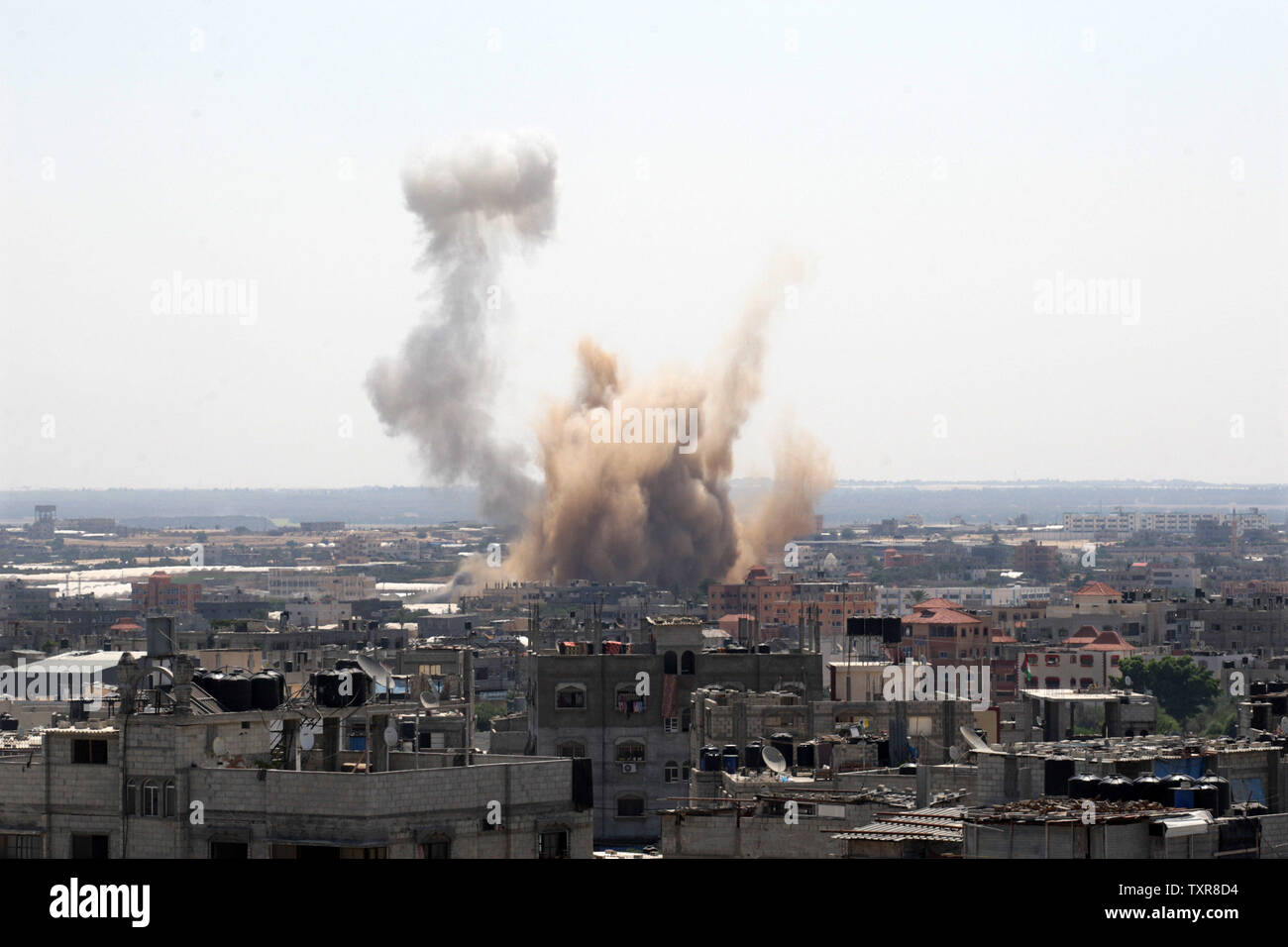 Smoke rises over Rafah in the southern Gaza Strip after an Israeli strike on August 8, 2014.   Hamas rejected an extension of the three-day truce being negotiated in Egypt since they say Israel rejected all of the Hamas demands. UPI/Ismael Mohamad Stock Photo