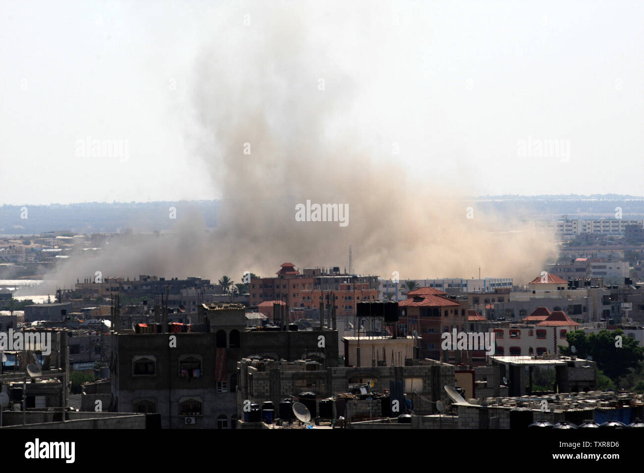 Smoke rises over Rafah in the southern Gaza Strip after an Israeli strike on August 8, 2014.   Hamas rejected an extension of the three-day truce being negotiated in Egypt since they say Israel rejected all of the Hamas demands. UPI/Ismael Mohamad Stock Photo