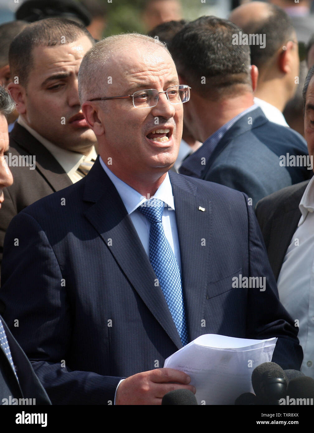 Palestinian prime minister Rami Hamdallah  delivers a speech during a tour to some of the areas worst hit by the 50-day war between Israel and Gaza militants in July and August, during a visit to the Gaza Strip, on October 9, 2014. Hamdallah crossed into Gaza today to hold the first cabinet meeting in the war-ravaged territory of a unity government formed by rivals Fatah and Hamas. UPI/Ismael Mohamad Stock Photo