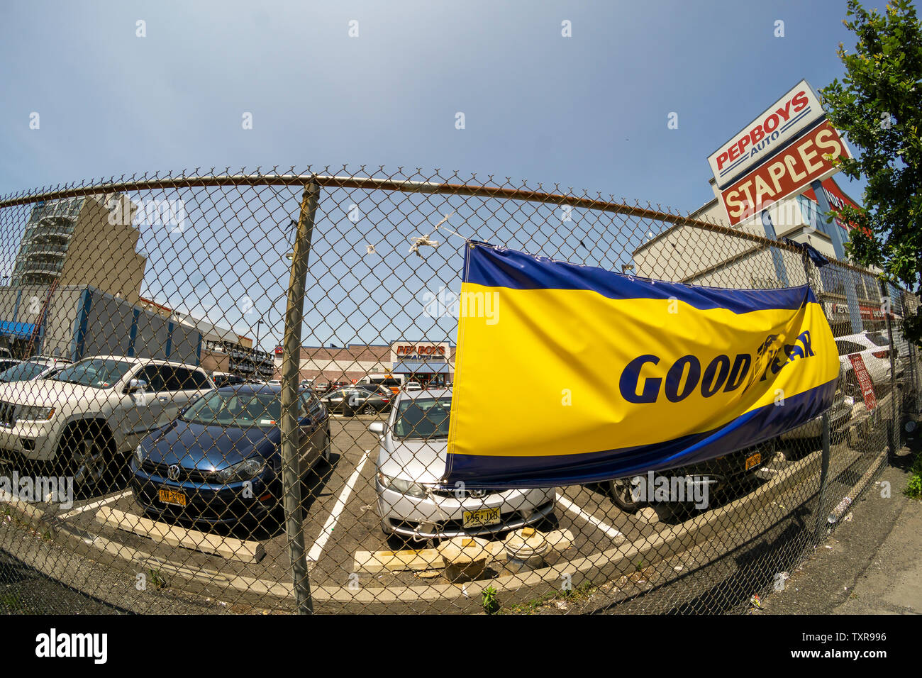 A sign advertising Goodyear tires outside of a Pep Boys auto parts store in the Park Slope neighborhood of Brooklyn in New York on Sunday, June 23, 2019. The Philadelphia based chain is known for its mascots Manny, Moe & Jack and has over 700 stores. (© Richard B. Levine) Stock Photo