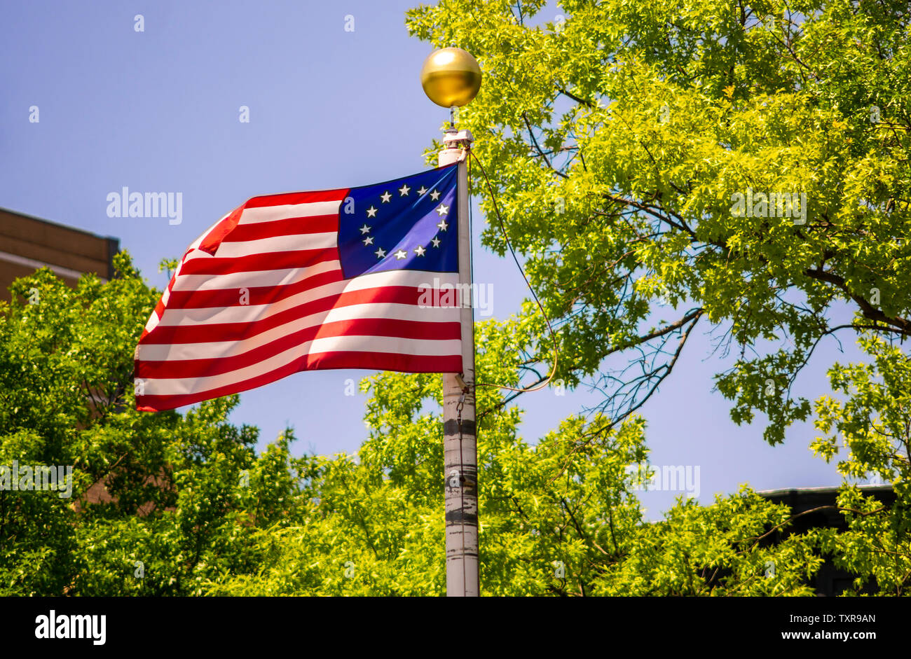 Commemorative thirteen star American flag flies in the breeze on a flagpole in a park in New York on Sunday, June 23, 2019. (© Richard B. Levine) Stock Photo