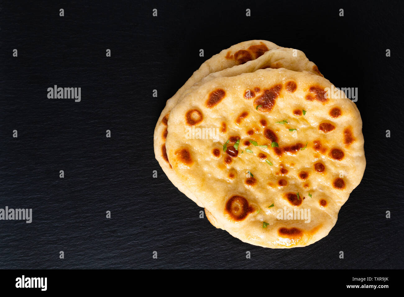 Food concept Homemade organic yogurt Naan on black slate board with