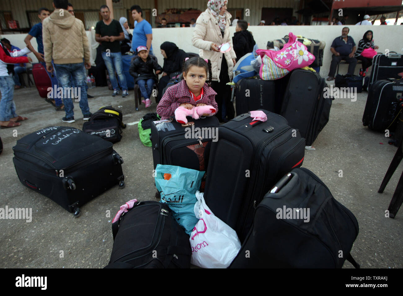 Palestinian wait with their belongings for travel permits to cross into Egypt through the Rafah border crossing on October 16, 2016 in the southern Gaza Strip. Egyptian authorities temporarily reopened Gaza's main gateway to the outside world, in both directions for two days.  Photo by Ismael Mohamad/UPI Stock Photo