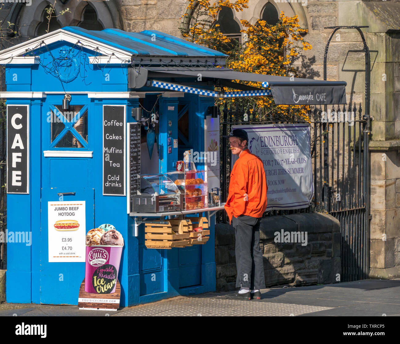 Canongate cafe – a small, converted old police box – with a man standing outside selling food and drink on the Royal Mile in Edinburgh, Scotland, UK. Stock Photo
