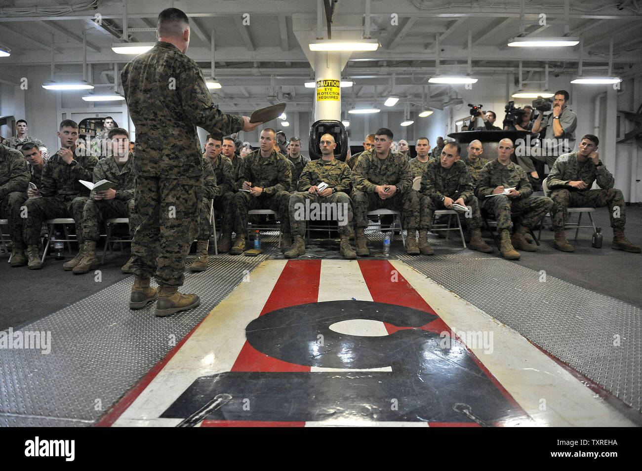 Marine Cpt. Edmond Clayton holds a leadership meeting for the 22nd Marine Expeditionary Unit on health, safety and what to expect in Haiti, while onboard the USS Bataan in route to assist in the relief effort following the 7.0 magnitude earthquake that stuck the county, January 16, 2010.   UPI/Kevin Dietsch... Stock Photo